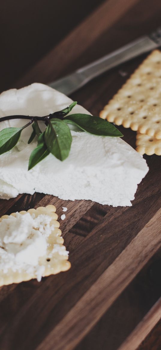 crackers, cheese, cutting board