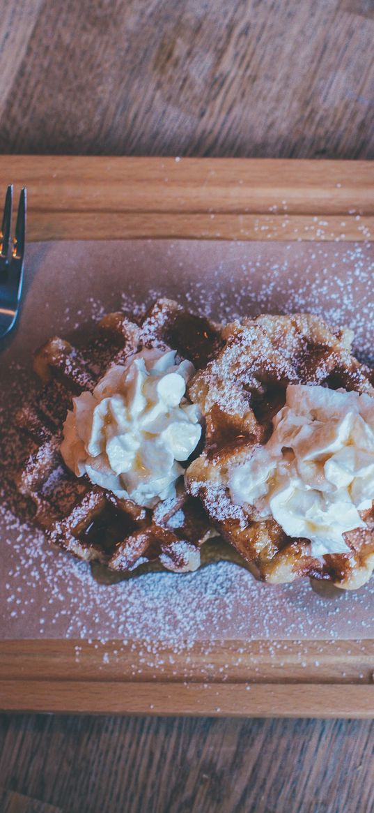 waffles, whipped cream, powder, cutting board