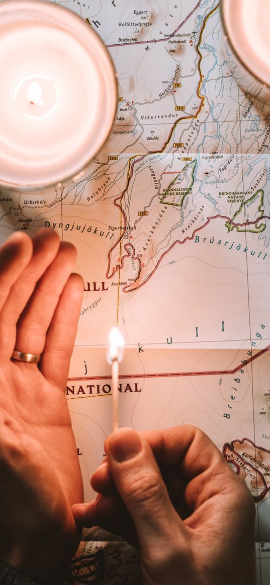 map, matchstick, hands, candle