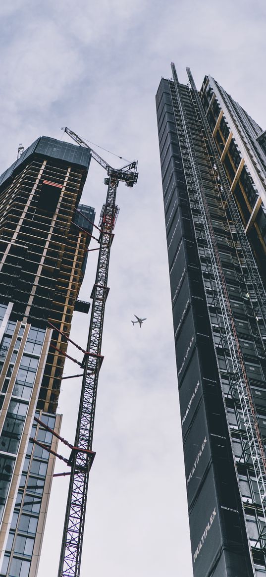 skyscrapers, crane, construction site, airplane, city, clouds, sky