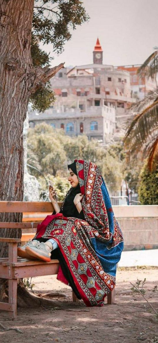 girl, national costume, bench, tree, houses, street, city, yemen