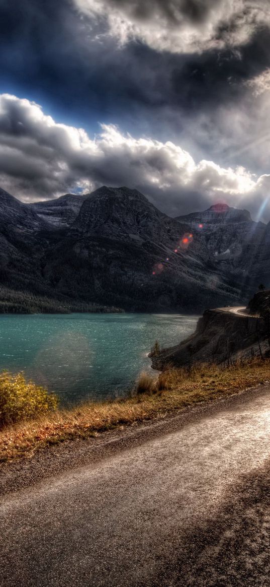 road, asphalt, sun, light, patches of light, midday, river, coast, marking, lines, double continuous, paint, clouds, volume