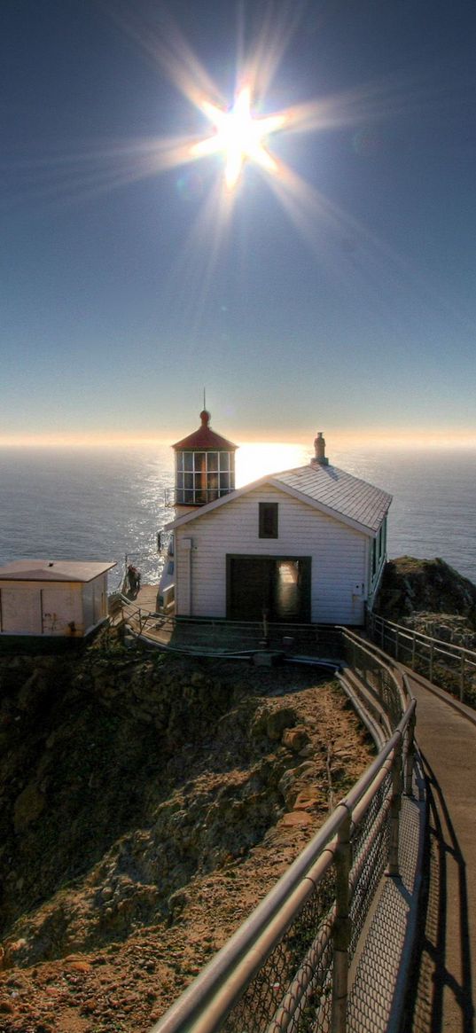 small house, sun, beacon, road, ocean, mountains