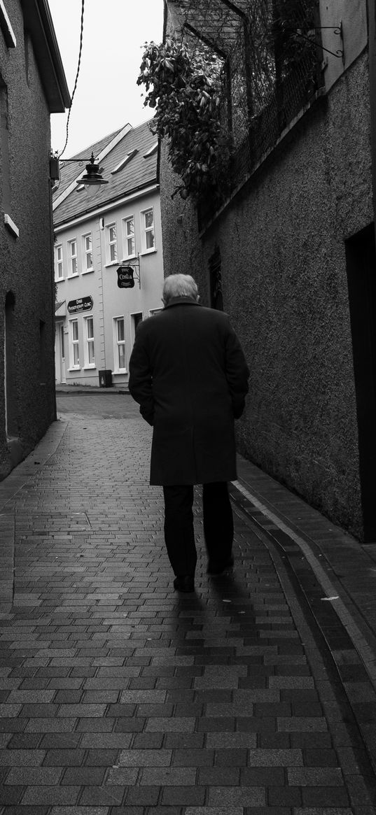 man, coat, street, houses, black and white