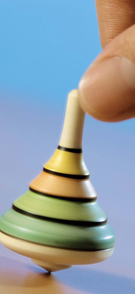 hand, spinning top, toy, blue background