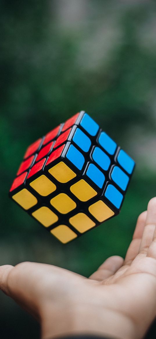 rubik's cube, hand, blurred background