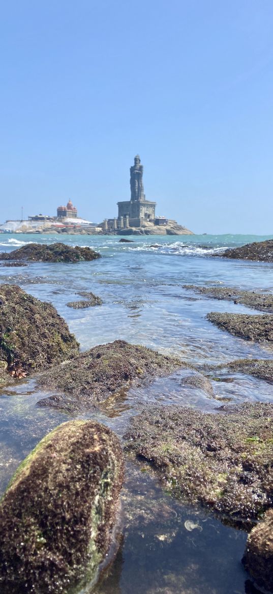 stones, seaweed, sea, statue, city, horizon, sky, nature