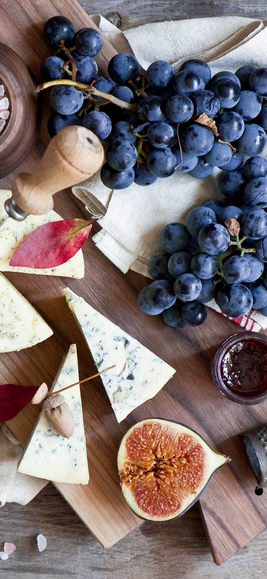 figs, grapes, cheese, board