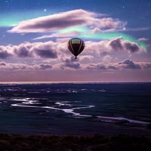 Preview wallpaper air balloon, ocean, aurora borealis, coast, clouds