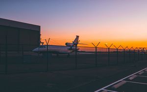 Preview wallpaper airplane, airport, runway, sunset