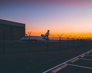 Preview wallpaper airplane, airport, runway, sunset