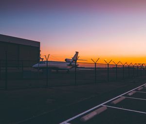 Preview wallpaper airplane, airport, runway, sunset