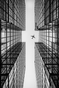 Preview wallpaper airplane, building, facade, bw, bottom view, hong kong