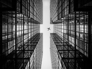 Preview wallpaper airplane, building, facade, bw, bottom view, hong kong