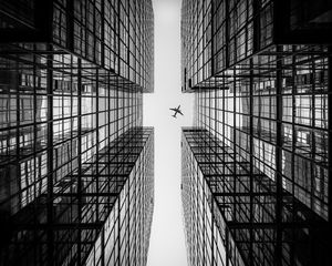 Preview wallpaper airplane, building, facade, bw, bottom view, hong kong