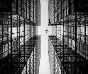 Preview wallpaper airplane, building, facade, bw, bottom view, hong kong