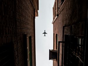 Preview wallpaper airplane, buildings, bottom view, flight