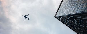 Preview wallpaper airplane, buildings, flight, bottom view, sky