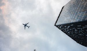 Preview wallpaper airplane, buildings, flight, bottom view, sky
