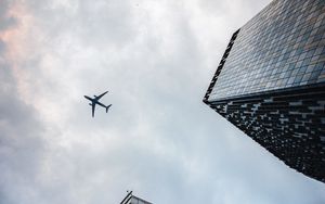 Preview wallpaper airplane, buildings, flight, bottom view, sky