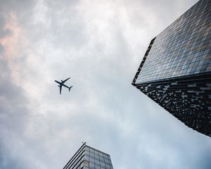 Preview wallpaper airplane, buildings, flight, bottom view, sky