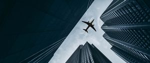 Preview wallpaper airplane, buildings, skyscrapers, sky