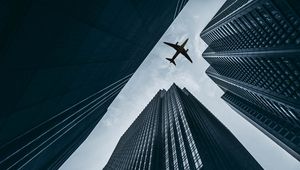 Preview wallpaper airplane, buildings, skyscrapers, sky