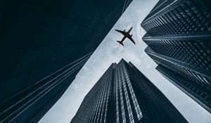 Preview wallpaper airplane, buildings, skyscrapers, sky