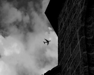 Preview wallpaper airplane, clouds, flight, building, black and white