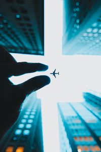 Preview wallpaper airplane, hand, buildings, sky, skyscrapers