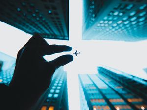 Preview wallpaper airplane, hand, buildings, sky, skyscrapers