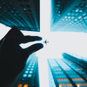 Preview wallpaper airplane, hand, buildings, sky, skyscrapers