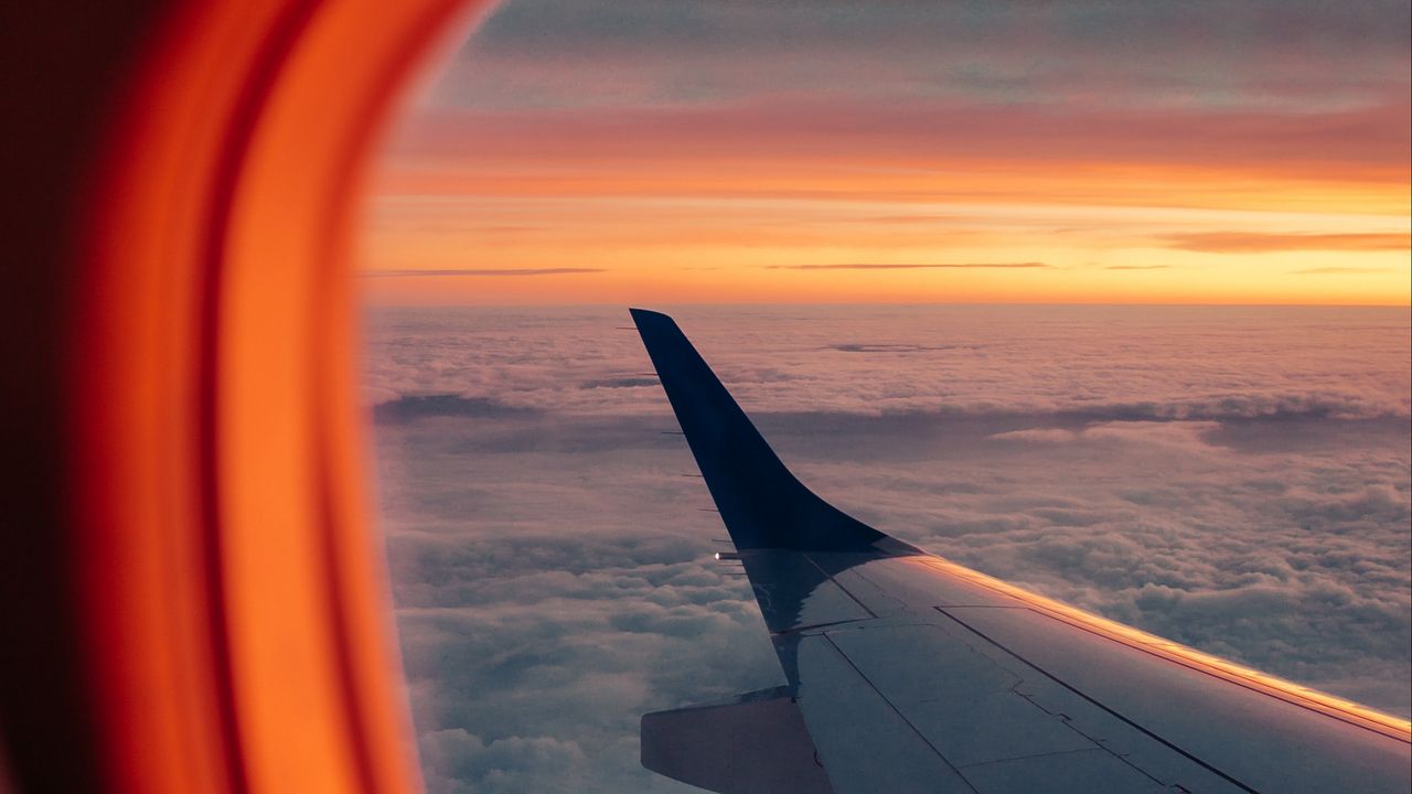 Wallpaper airplane, porthole, wing, sunset, clouds, sky