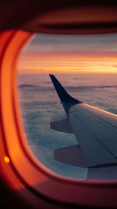 Preview wallpaper airplane, porthole, wing, sunset, clouds, sky