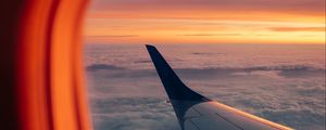 Preview wallpaper airplane, porthole, wing, sunset, clouds, sky