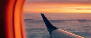 Preview wallpaper airplane, porthole, wing, sunset, clouds, sky