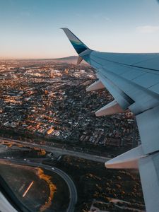 Preview wallpaper airplane, wing, city, aerial view, overview