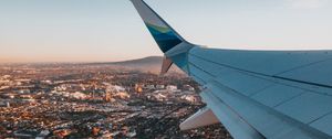 Preview wallpaper airplane, wing, city, aerial view, overview