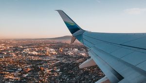 Preview wallpaper airplane, wing, city, aerial view, overview