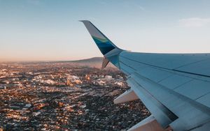 Preview wallpaper airplane, wing, city, aerial view, overview