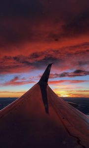 Preview wallpaper airplane, wing, clouds, sky, sunset