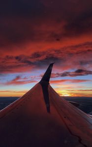 Preview wallpaper airplane, wing, clouds, sky, sunset