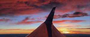 Preview wallpaper airplane, wing, clouds, sky, sunset