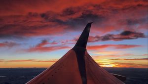 Preview wallpaper airplane, wing, clouds, sky, sunset