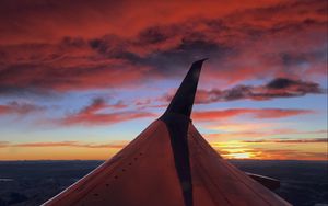 Preview wallpaper airplane, wing, clouds, sky, sunset