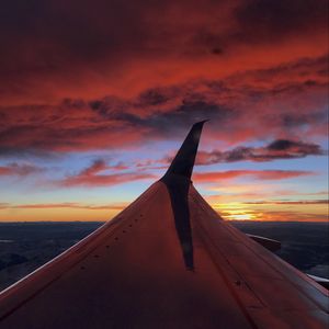 Preview wallpaper airplane, wing, clouds, sky, sunset