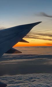 Preview wallpaper airplane, wing, clouds, flight, sky, sunset, dawn