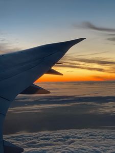 Preview wallpaper airplane, wing, clouds, flight, sky, sunset, dawn