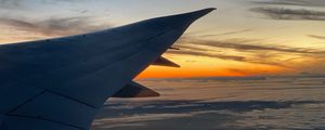 Preview wallpaper airplane, wing, clouds, flight, sky, sunset, dawn