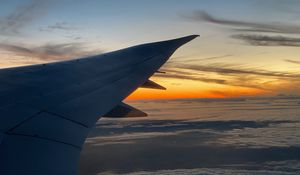 Preview wallpaper airplane, wing, clouds, flight, sky, sunset, dawn